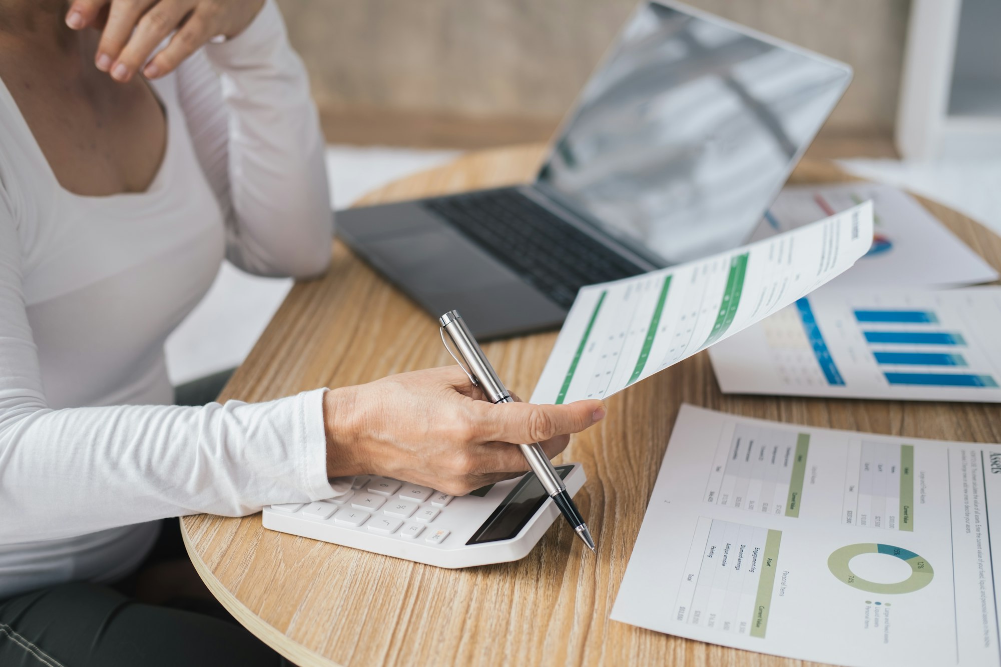 Elderly Asian woman calculating costs of household. Personal finances management concept.